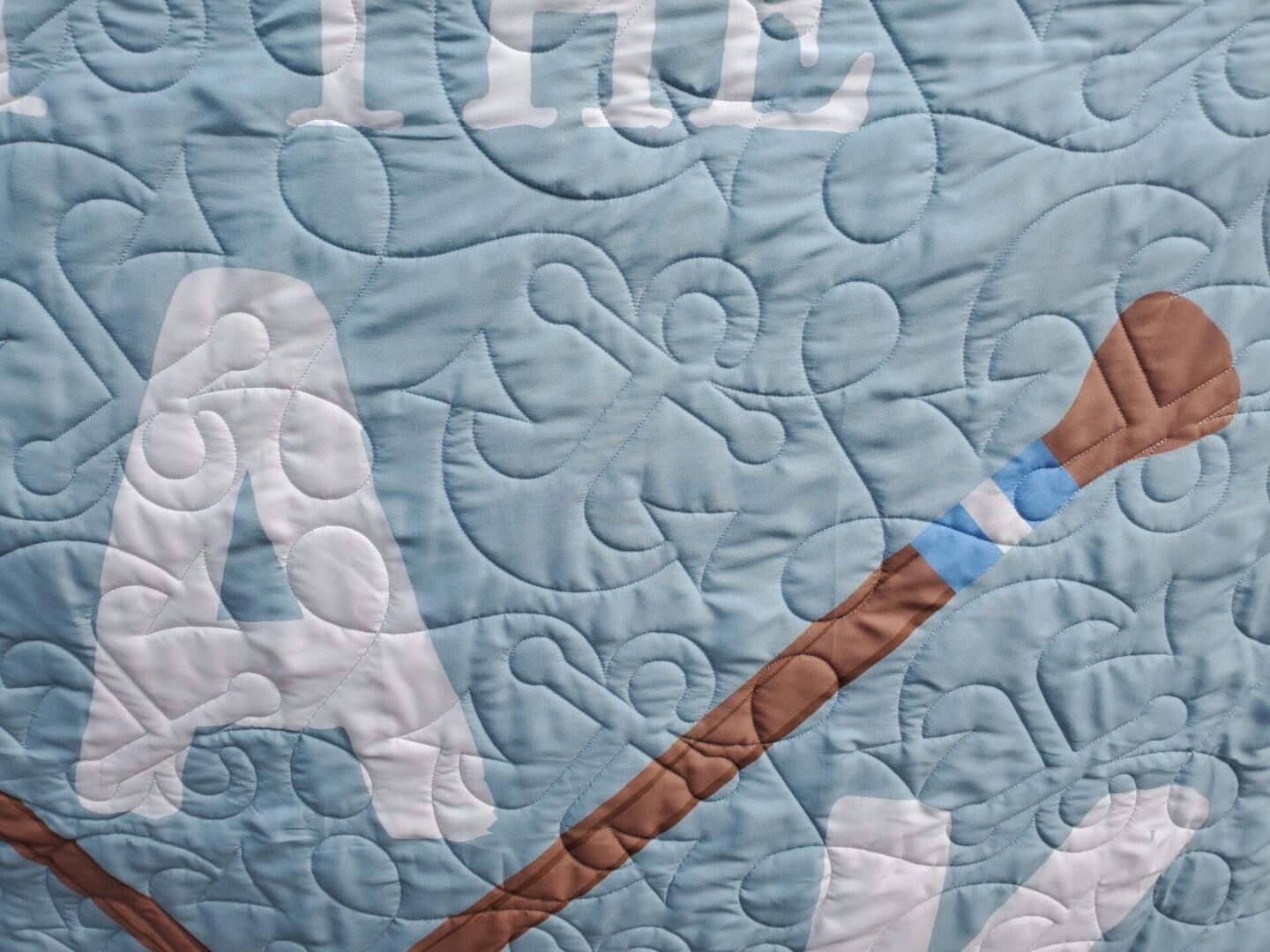 A close up of the quilt with a picture of a bear