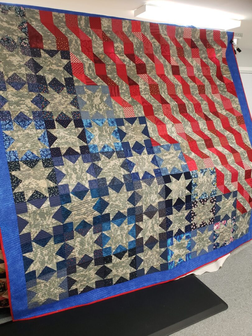 A quilt that is made of different colored fabrics.