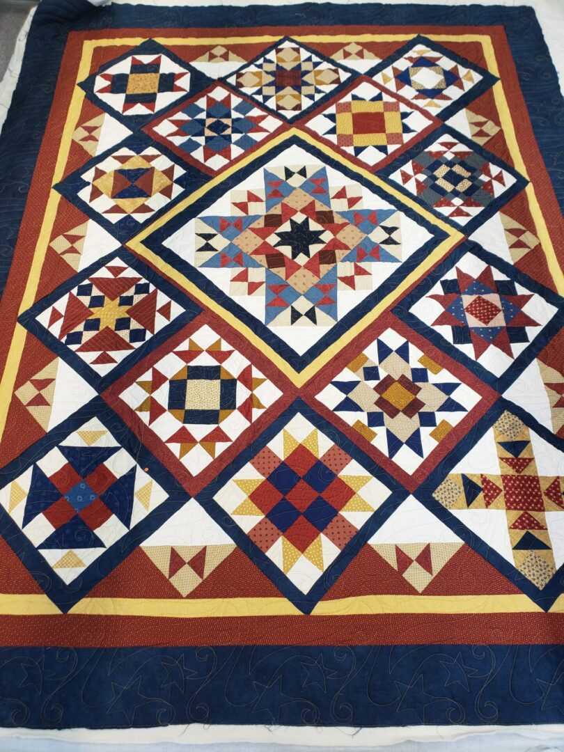A quilt with different designs on it.